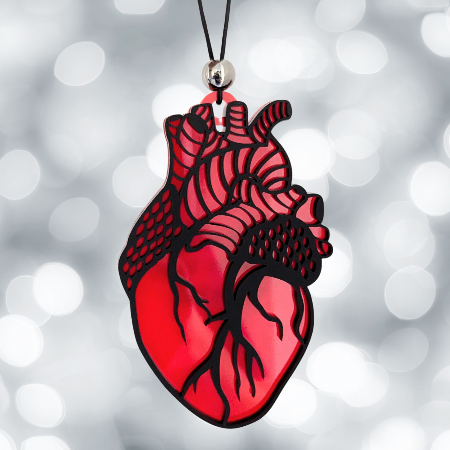 Anatomical heart ornament made from blue and red acrylic with optional personalization on the back.