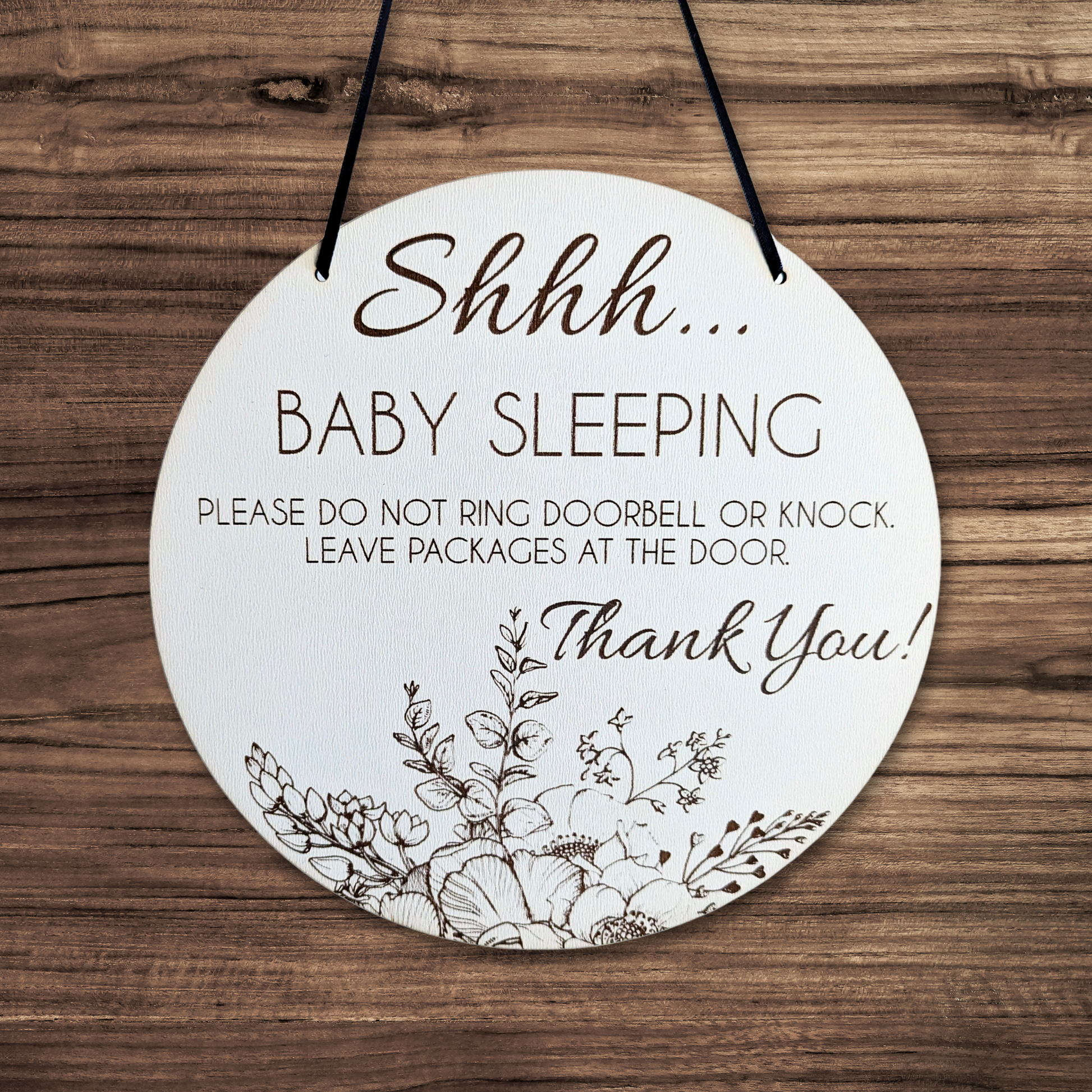 Sign reads: Shhh... Baby sleeping please do not ring Doorbell or knock. Leave packages at the door. Thank you!