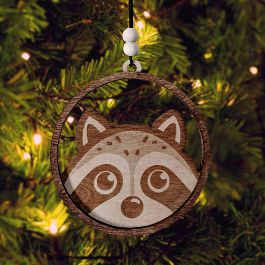 Adorable wooden christmas ornament of a racoon peering over the edge of a circle. 