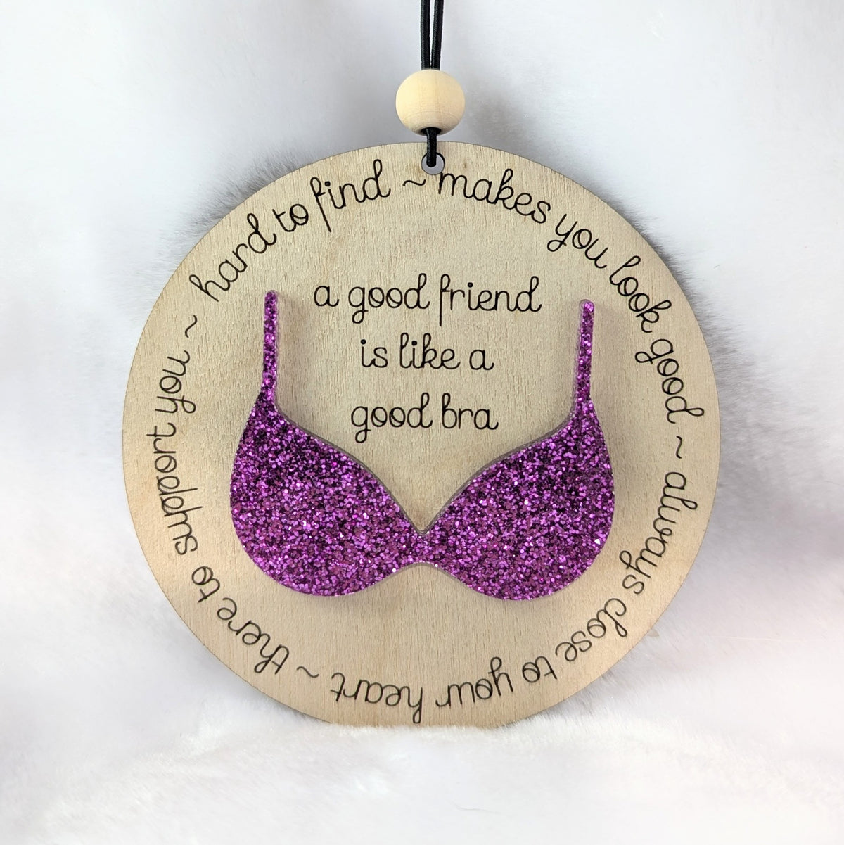 Friendship ornament with a purple bra. Reads: A good friend is like a good bra. 
