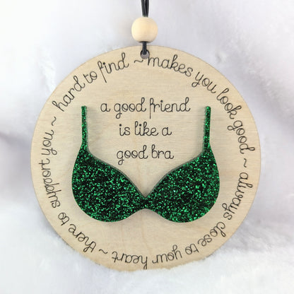 Friendship ornament with a green bra. Reads: A good friend is like a good bra. 