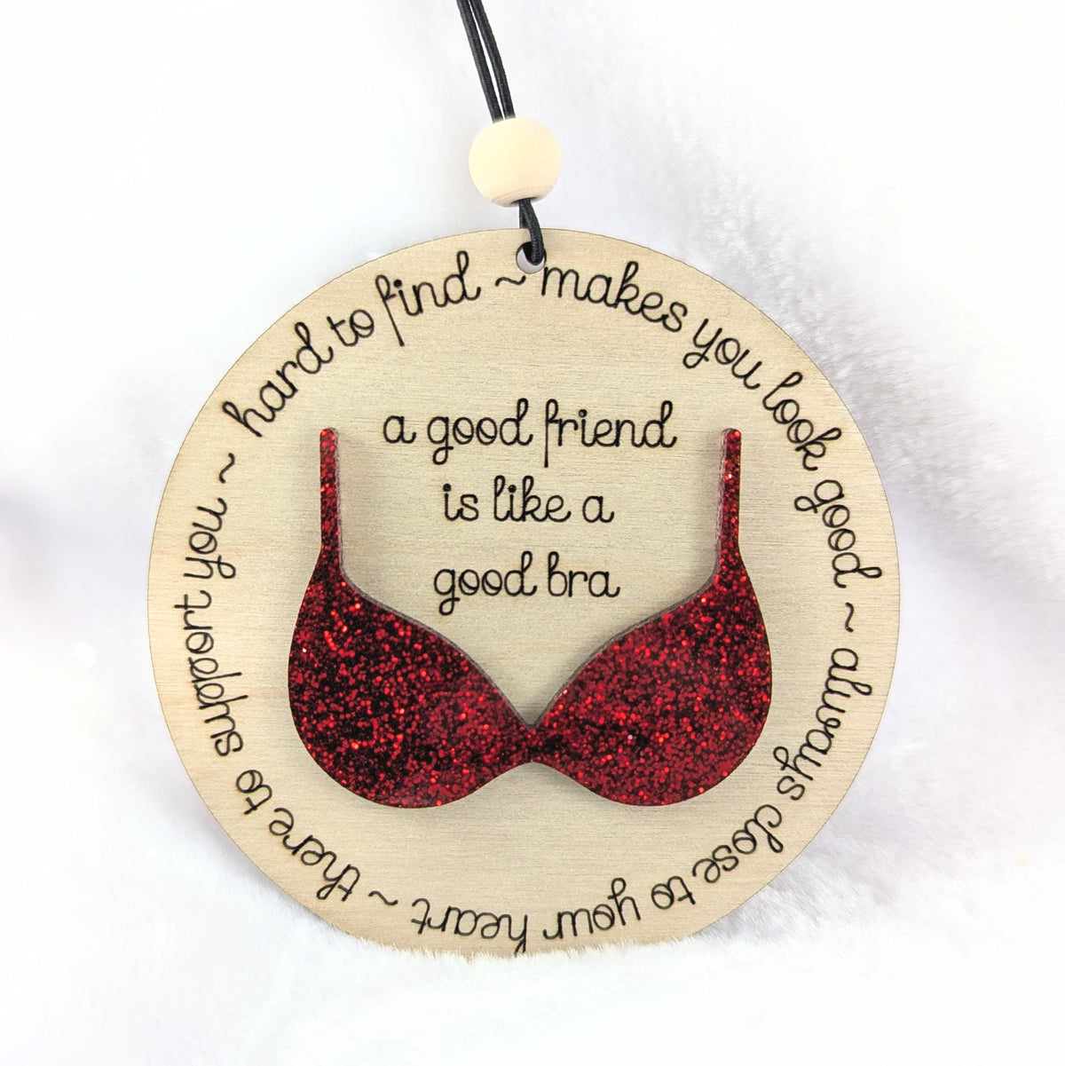 Friendship ornament with a red bra. Reads: A good friend is like a good bra. 